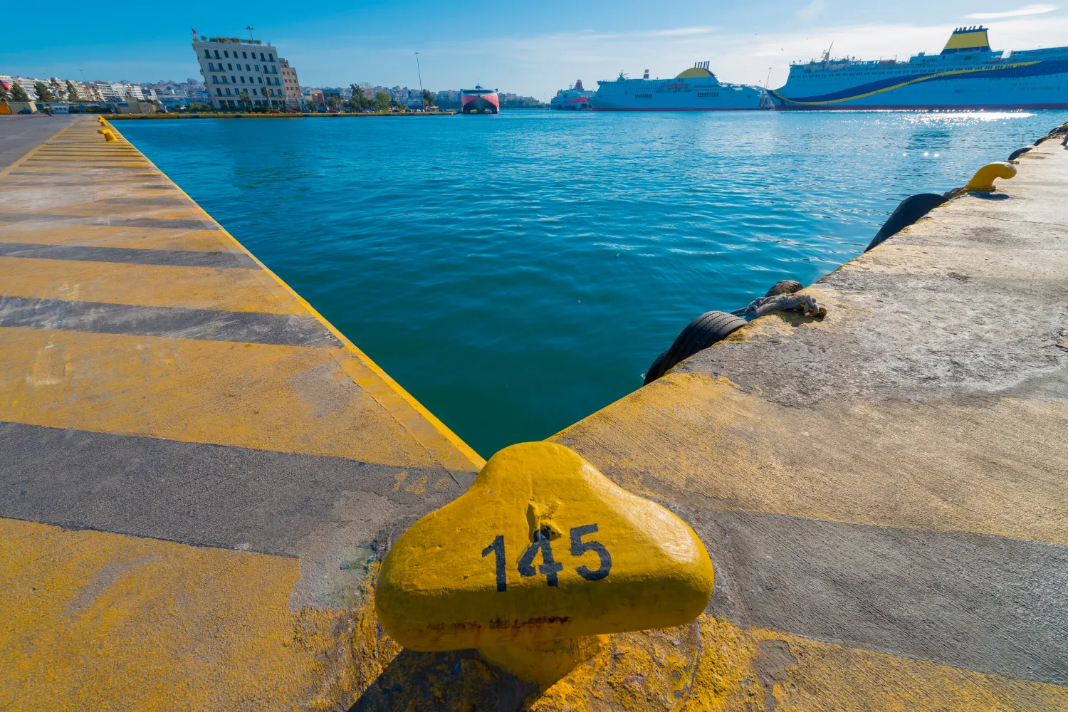 Piraeus Greece Piraeus,Yellow Rusty Metal Bollard And Ship Rope Harbor At Sunny Day With Ships In Background 1 image